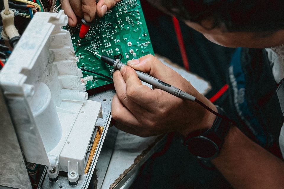 Engineer repairing a circuit board