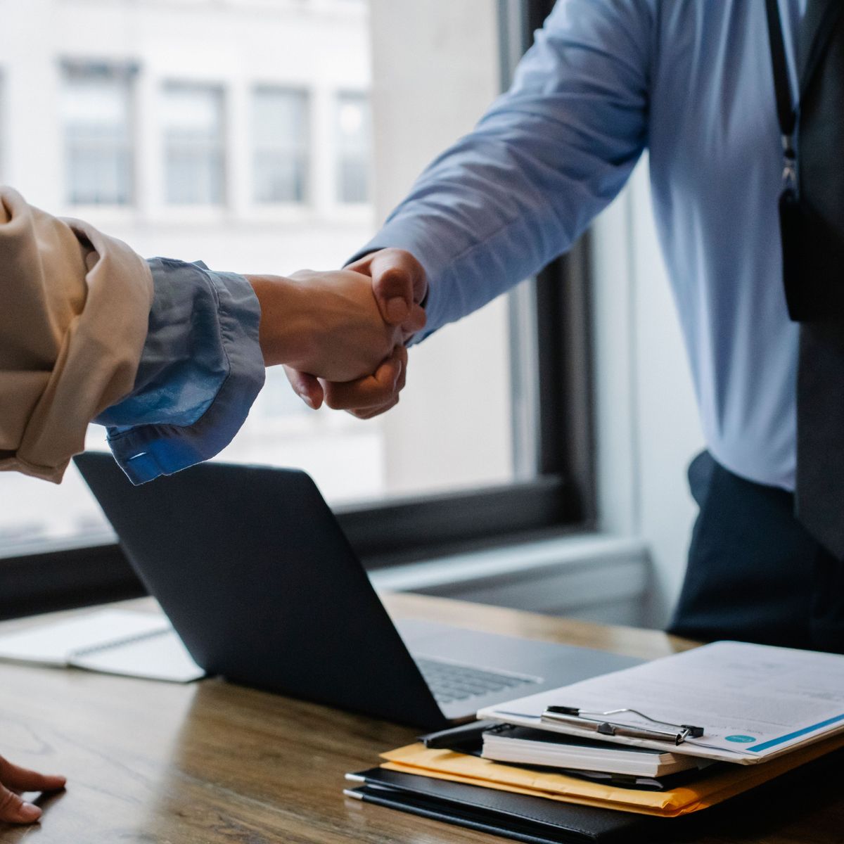 Business handshake over a signed agreement